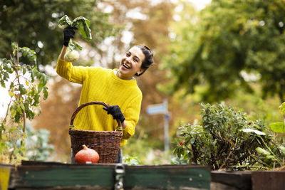 Young man holding food while standing outdoors