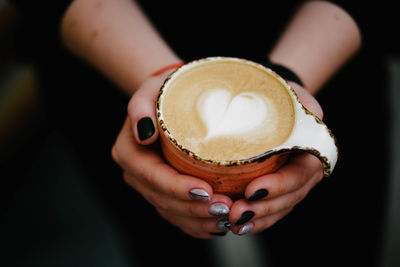 Close-up of woman holding coffee cup