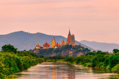 View of temple amidst buildings against sky