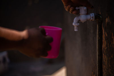 Midsection of person holding drink