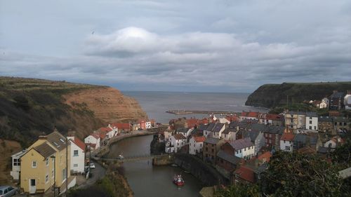 High angle view of town against cloudy sky