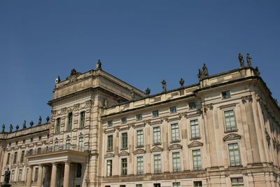 Low angle view of historic building against blue sky