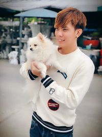 Cute boy with dog standing outdoors