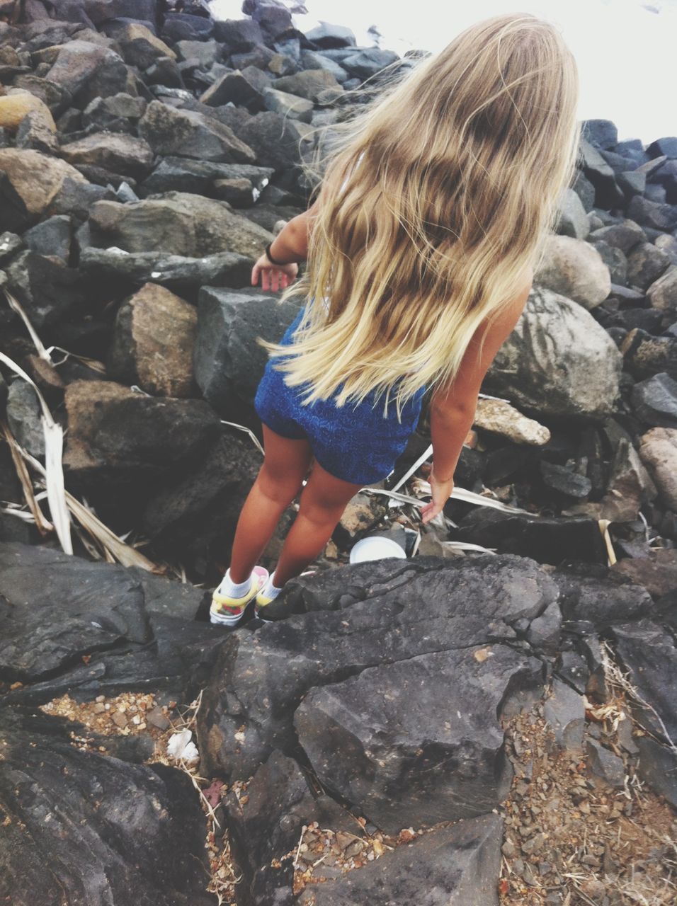 lifestyles, leisure activity, full length, casual clothing, standing, rock - object, childhood, person, girls, rear view, long hair, holding, day, outdoors, young women, elementary age, side view