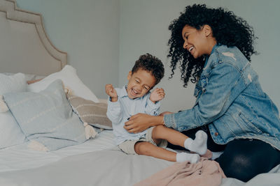 Friends sitting on bed