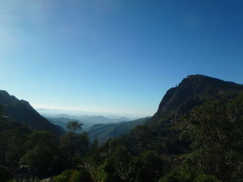 Scenic view of mountains against clear blue sky