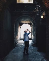 Full length of man standing in front of building