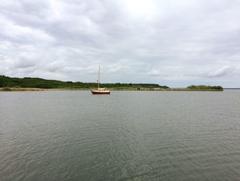 Boat sailing on river against sky