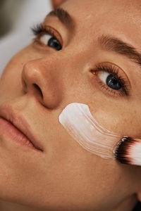 Cropped image of woman applying nail polish