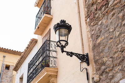 Low angle view of street light against building