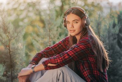 Portrait of young woman looking away outdoors