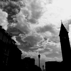 Low angle view of building against cloudy sky