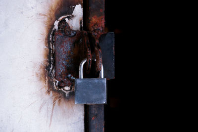 Close-up of padlock on metal door