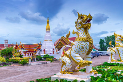 White thai lion statue in front of wat phra that choeng chum, sakon nakhon province, thailand