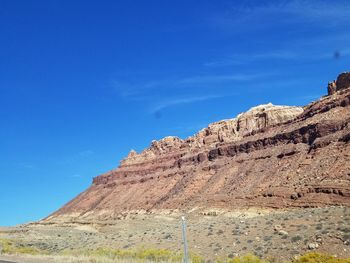 Low angle view of rock formations against blue sky