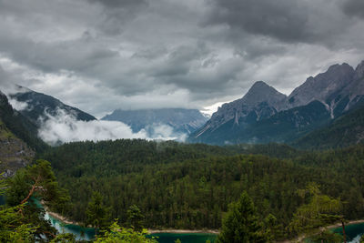 Scenic view of mountains against cloudy sky