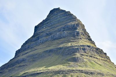 Low angle view of rock formation against sky