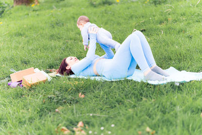 Side view of women lying on grass