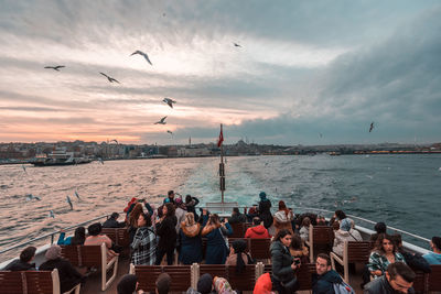 People flying over sea against sky