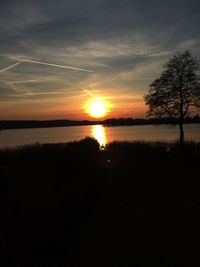 Scenic view of lake against sky during sunset