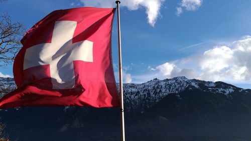 Low angle view of flag against mountain