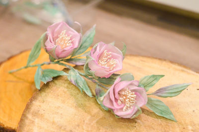 Close-up of pink rose on table