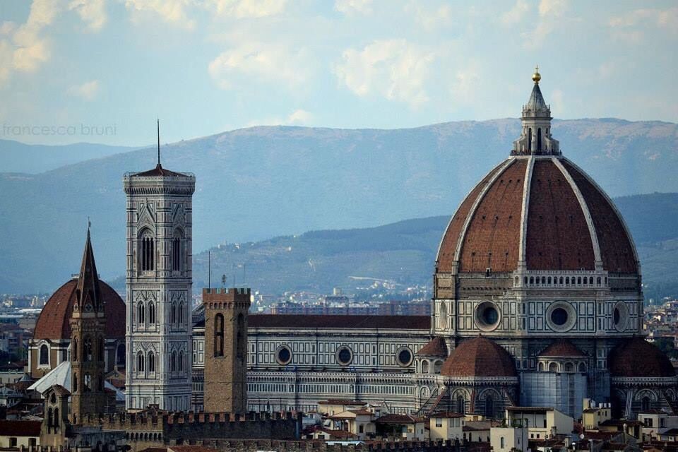 architecture, built structure, place of worship, religion, dome, spirituality, church, sky, famous place, travel destinations, cathedral, mountain, tourism, cloud - sky, city, cloud, day, capital cities, outdoors, mountain range, no people, cloudy, blue