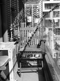 Empty chairs and tables against buildings