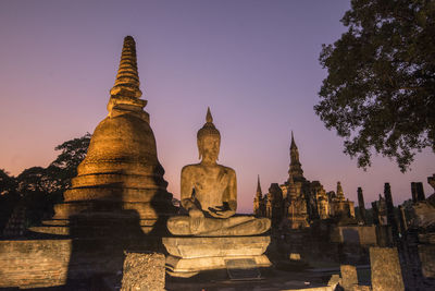 Statue of temple against building