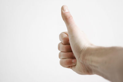 Close-up of hand over white background