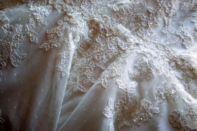 Full frame shot of illuminated lighting on white wedding dress