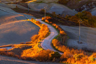 Scenic view of road by mountain against sky