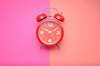 Close-up of clock against red background