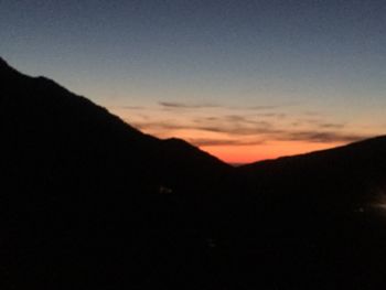 Silhouette mountains against sky during sunset