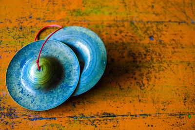 Close-up of antique cymbals on table