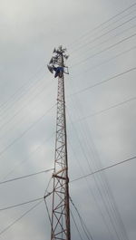 Low angle view of electricity pylon against sky