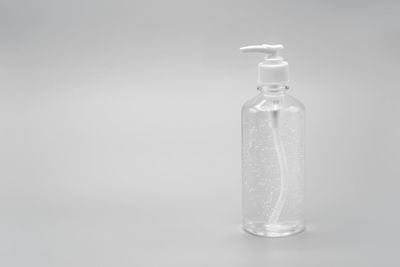 Close-up of water bottle on table against white background