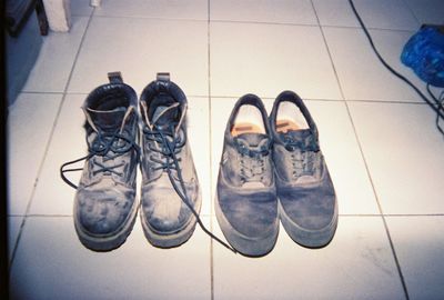 Low section of shoes on tiled floor