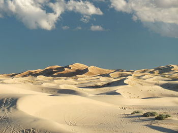Idyllic shot of sand dunes in desert against sky