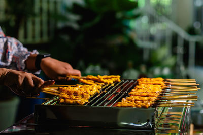 Man preparing food on barbecue grill