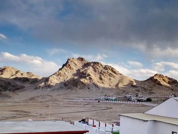 Panoramic view of buildings and mountains against sky