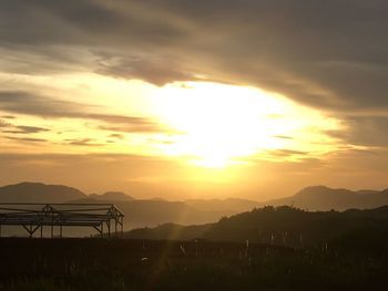 Scenic view of silhouette mountains against sky during sunset