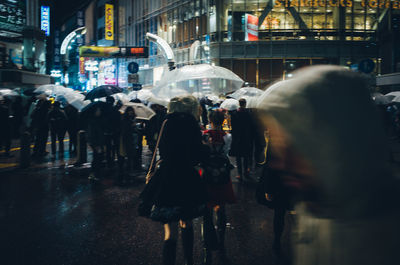 Crowd on illuminated city at night