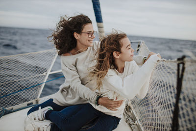 Young couple sitting on sea shore