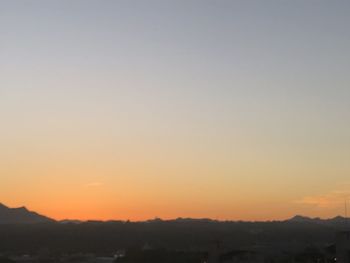 Scenic view of silhouette landscape against clear sky during sunset