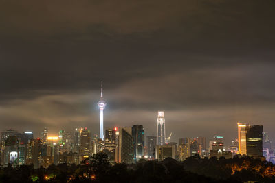 Illuminated buildings against sky at night