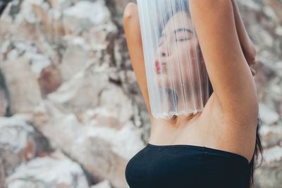 Close-up of young woman covered in plastic