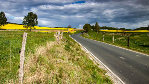 Empty road along countryside landscape