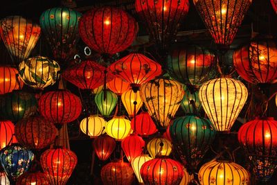 Low angle view of illuminated lanterns hanging at night