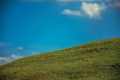 Scenic view of landscape against blue sky